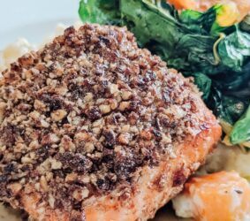 crusted salmon on a green salad