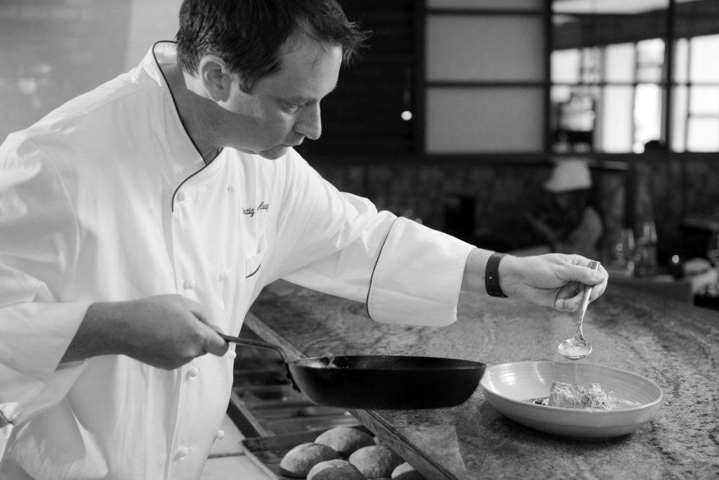 a chef in the kitchen cooking away